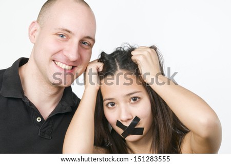 head and shoulder shot of a couple is quarrel with tape on the mouth 
