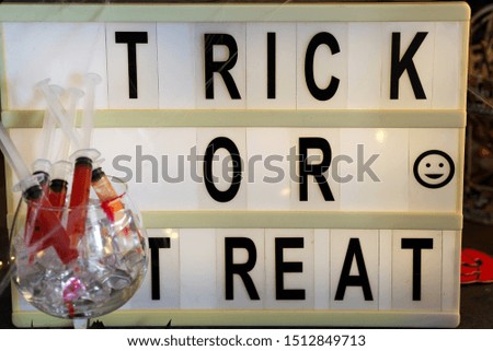 Lightbox with the text Trick or Treat. Flat lay of accessory decoration Halloween festival background concept.