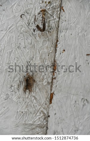 curved and rusty nail on wood 