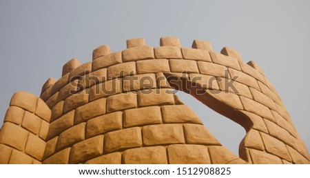 Yellowish repeat pattern wall with sky background photo