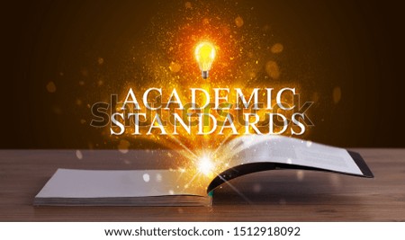 ACADEMIC STANDARDS inscription coming out from an open book, educational concept