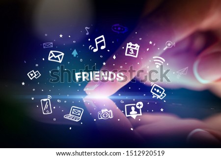 Finger touching tablet with drawn social media icons and FRIENDS inscription, social networking concept