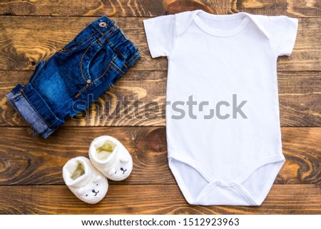 Mockup of white baby bodysuit shirt, slippers and jeans