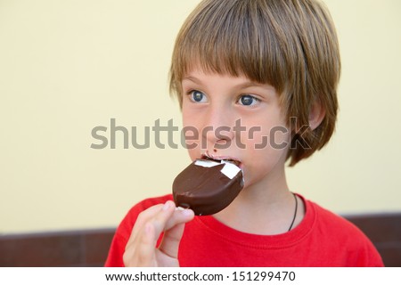 cute kid boy eating ice cream outdoor