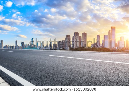 Empty asphalt road and Chongqing cityscape at sunset Royalty-Free Stock Photo #1513002098