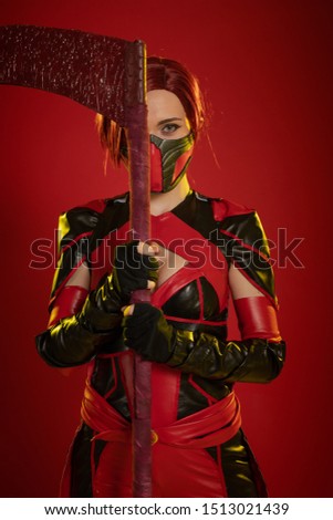 Actress woman in mask and costume of fictional fantasy character posing on red background