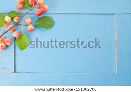 Fresh red apples with leaves on the old wooden background  