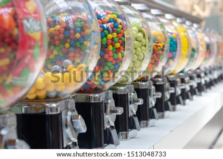 Gumball machines in a row close angle Royalty-Free Stock Photo #1513048733