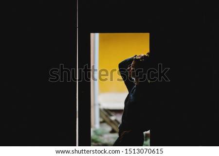Girl posing stands near a door hole