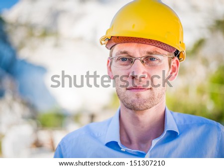Portrait of happy young foreman with hard hat