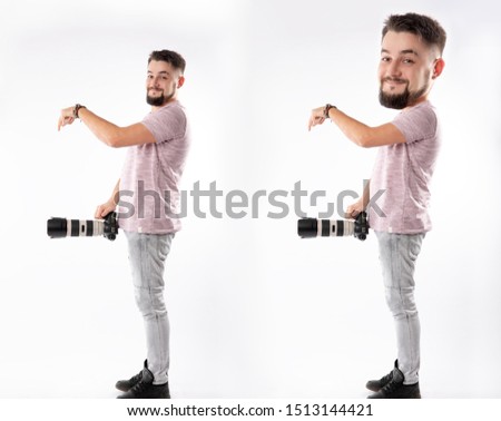 full-length photographer stands on a white background and puts the camera below the belt