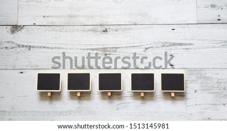 Five small clip chalkboard wood frame array line on white wood table top view nature shadow above space,Idea signboard concept