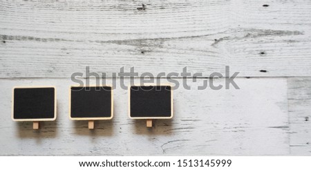 Three small chalkboard clip array line on white wood table nature shadow above space,Idea notice blackboard concept
