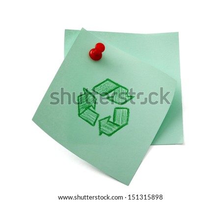 Recycle sign on green sheet of paper