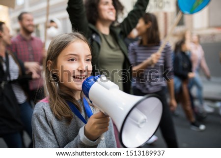 Small child with amplifier on global strike for climate change.