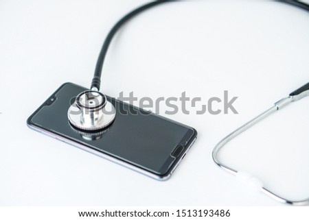 Phone repair and service concept isolated white background.Smartphone being diagnosed with a stethoscope.
