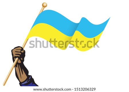 The hand holding the Ukraine flag.