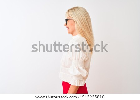 Middle age businesswoman wearing shirt and glasses standing over isolated white background looking to side, relax profile pose with natural face with confident smile.