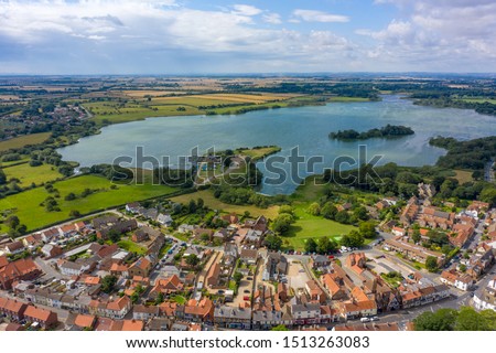 Aerial View of buildings and the mere in the seaside town of Hornsea during Summer of 2019 Royalty-Free Stock Photo #1513263083