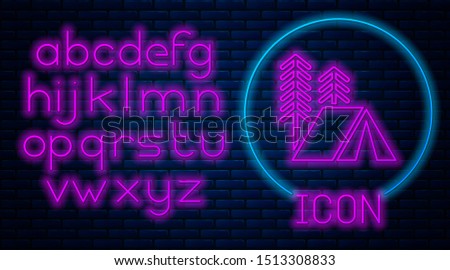 Glowing neon Tourist tent icon isolated on brick wall background. Camping symbol. Neon light alphabet. Vector Illustration
