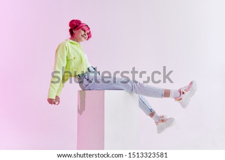 young woman with pink hair in jeans young
