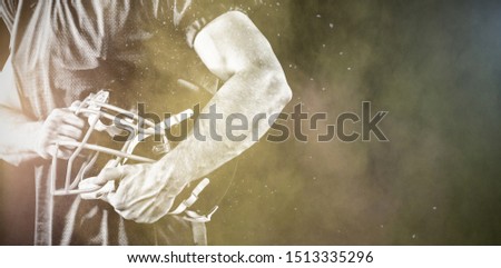 American Football Player against splashing of color powder