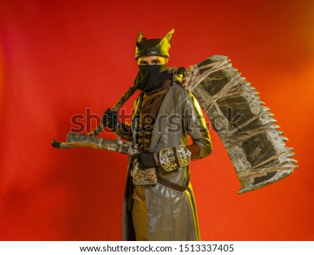 Actor a man in a mask and in costumes of fictional fantasy characters posing on a red background