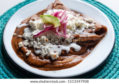 Traditional mexican tacos with beans sauce and fresh cheese also called "Enfrijoladas"