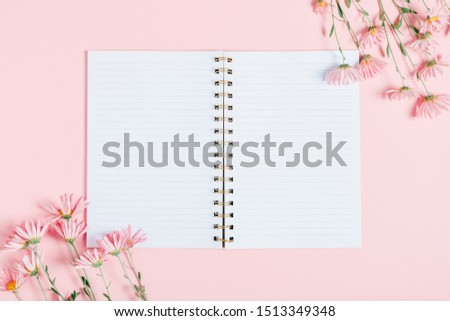 Beautiful flowers composition. Pink flowers and open notebook on pastel pink background. Valentines Day, Happy Women's Day, Mother's day. Flat lay, top view, copy space