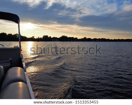 Pontoon on Lake Lansing During Sunset Royalty-Free Stock Photo #1513353455