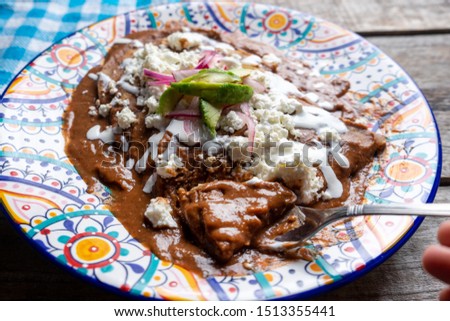 Traditional mexican tacos with beans sauce and fresh cheese also called "Enfrijoladas"