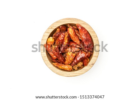 Lot of whole dry red chili pepper peperoncino in wooden bowl flatlay isolated on white background Royalty-Free Stock Photo #1513374047