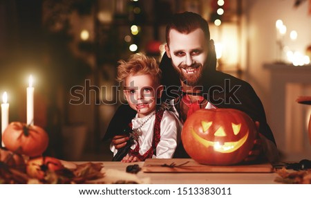 happy family   father and child son in costumes and makeup on a celebration of Halloween
