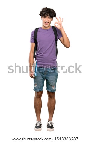 A full-length shot of a Young student man showing ok sign and thumb up gesture over isolated white background