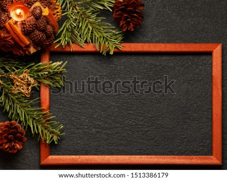 Christmas composition, blank for greeting card or other design - Christmas tree branches with wooden frame and decorations on a dark background, flat lay, top view, copy space, place for text