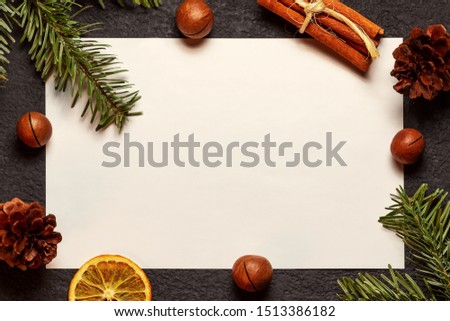 Christmas composition, blank for greeting card or other design - old paper with a Christmas tree branch and decorations on a dark background, flat lay, top view, copy space, place for text