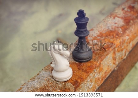chess pieces on rusty iron in nature