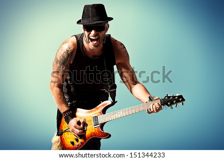 Rock musician is playing electrical guitar. Royalty-Free Stock Photo #151344233