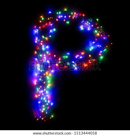 The letter "P" of the English alphabet from a multi-colored electric garland on a black isolated background. New Year's alphabet.Wreath of colored bulbs. Alphabet for Christmas holidays card template.