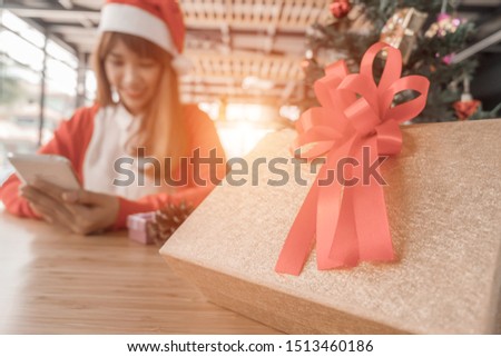 Merry christmas happy woman holding smartphone for happy holidays in home, christmas concept

