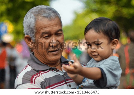 a grandfather joking with his grandchild