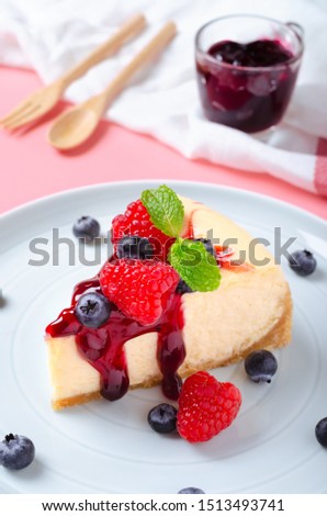 Classic plain New York Cheesecake looks delicious on plates and pastel colored backgrounds. The concept looks cute and sweet.