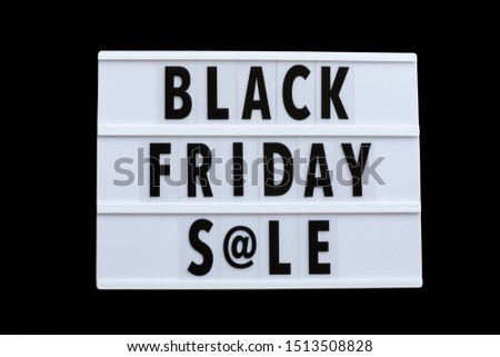 Creative promotion composition Black friday sale text on lightbox on black background. Flat lay, top view, overhead, mockup