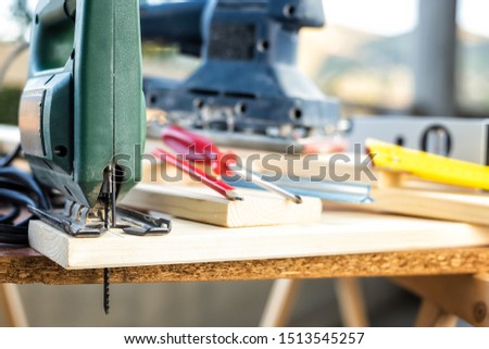 Professional woodworking tools, manual electric saw for cutting wood. Housework do it yourself. Stock photography.