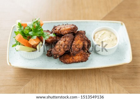 chicken wings grill. Serving on a white plate on a table. Barbecue restaurant menu, a series of photos of different meats