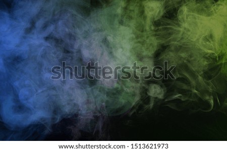 Abstract smoke on a dark background.  Movement of color smoke. Smoke texture