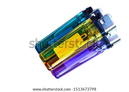 Colorful lighters on a white background, made in Thailand.