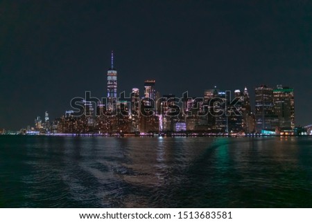 New York city skyline at night viewed from Hudson river