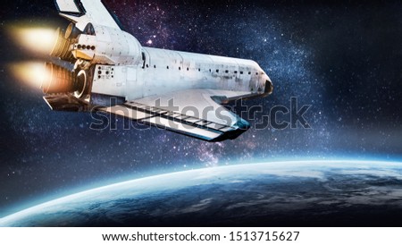 Space shuttle take off in the space from Earth. Stars and Planet on background. Atmosphere. Elements of this image furnished by NASA