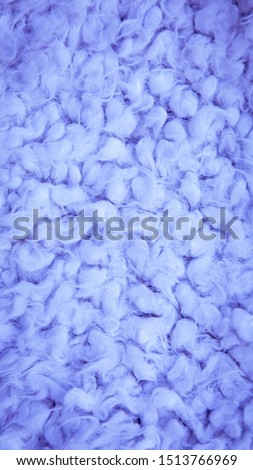 Close-up of wool, karakul, fur texture background. Vertical fur background. purple cotton, sheepskin texture.